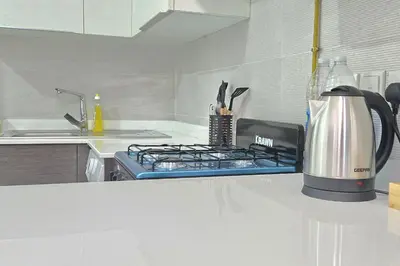 a kitchen with a stove top oven next to a sink at Joya Verde Residence - Studio with Balcony in Dubai