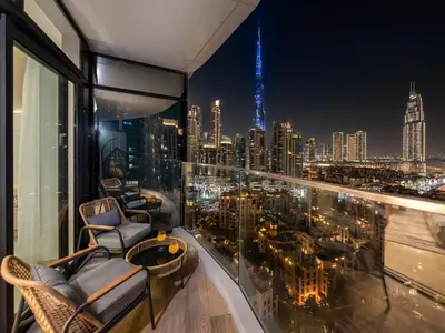 a balcony with a view of the city at night at Royal Vista - Luxe 4BR Penthouse with Burj Khalifa View at Imperial Avenue - Downtown in Dubai