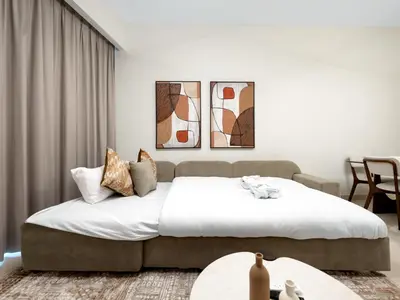 a bedroom with a large bed with white sheets at Royal Vista - Luxe 4BR Penthouse with Burj Khalifa View at Imperial Avenue - Downtown in Dubai