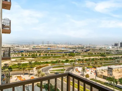 a view of a city from a balcony at Modern 2 Bed in Dubai Hills Near Mall & Park in Dubai
