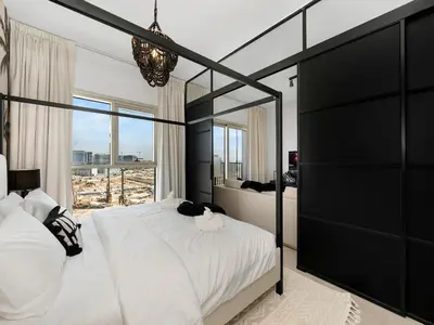 a bedroom with a large bed and a large window at Modern 2 Bed in Dubai Hills Near Mall & Park in Dubai