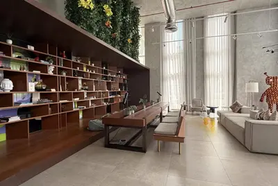 a living room with a lot of bookshelves at Modern 2 Bed in Dubai Hills Near Mall & Park in Dubai