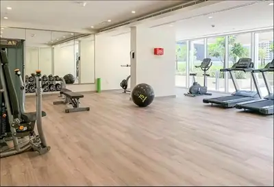 a gym with treadmills and machines in a room at Elegant 1BR Apartment at DAMAC Vera in Business Bay in Dubai