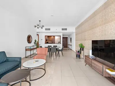 a living room with a couch and a dining room at Luxury 2-BDR in Downtown 8 BLVD Walk in Dubai