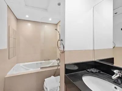 a bathroom with a sink and a bath tub at Luxury 2-BDR in Downtown 8 BLVD Walk in Dubai