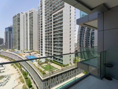 an apartment balcony with a view of a city at Sunlit Studio Haven Luxury Living in Majestine in Dubai