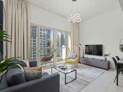 a living room with a couch and a tv at Prime Luxe 1BR w SofaBed -Sleeps 4 - In Marina View in Dubai