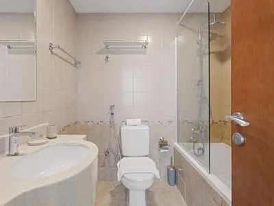 a bathroom with a toilet and a sink and a shower at Prime Luxe 1BR w SofaBed -Sleeps 4 - In Marina View in Dubai