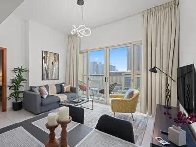 a living room with a couch and a table at Prime Luxe 1BR w SofaBed -Sleeps 4 - In Marina View in Dubai