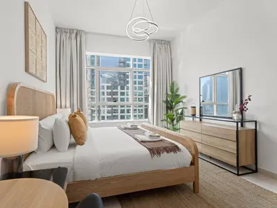 a bedroom with a bed and a large window at Prime Luxe 1BR w SofaBed -Sleeps 4 - In Marina View in Dubai