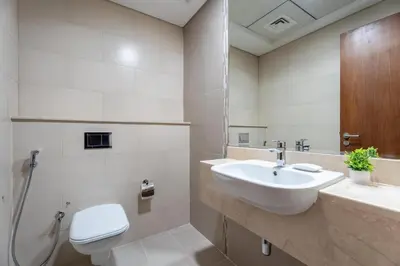a bathroom with a sink and a toilet at GuestReady - 1 BHK | Breathtaking Skyline Views in Dubai