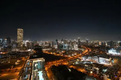 a night view of a city with a lot of lights at GuestReady - 1 BHK | Breathtaking Skyline Views in Dubai