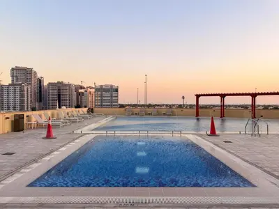 a swimming pool with orange cones in a city at GuestReady - 1 BHK | Breathtaking Skyline Views in Dubai