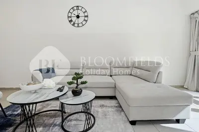 a living room with a couch and two tables at Bloomfields Iconic 2BR Elite Residence Marina in Dubai