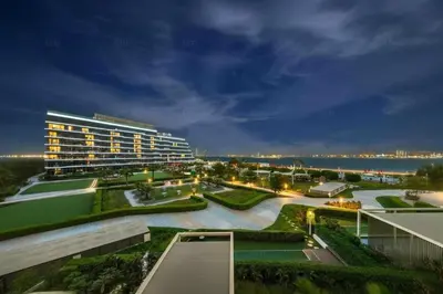 a view of a large building at night at Palm Jumeirah, Fancy 2 Bedroom suite! in Dubai