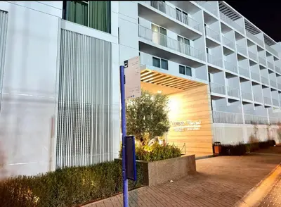 a building with a sign in front of it at Vogue JVC Luma22 near Circle Mall, Studio Apartment with Balcony and Vibrant Community View, Access to all Amenities in Dubai