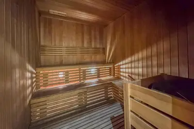 a wooden sauna with a bed in it at Upscale Studio in Park View JVC in Dubai