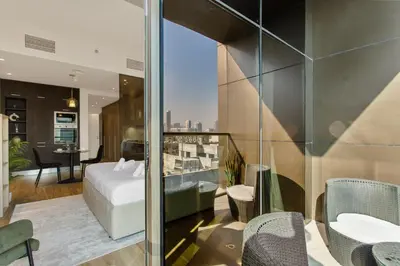 a hotel room with a bed and a view of the city at Upscale Studio in Park View JVC in Dubai