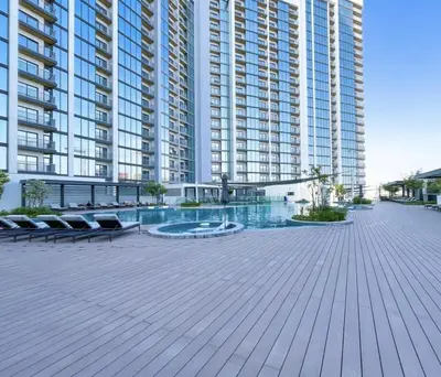 a large apartment building with a pool in front of it at Luxury 1BR Apartment Near Burj Khalifa Skyline Pool View in Dubai