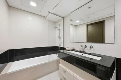 a bathroom with a sink and a mirror at Ultra Modern Downtown Residence Steps Away from Burj Khalifa and Dubai Mall in Dubai