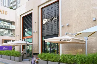 a restaurant with umbrellas in front of a building at Ultra Modern Downtown Residence Steps Away from Burj Khalifa and Dubai Mall in Dubai