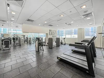 a gym with treadmills and exercise equipment in a building at Ultra Modern Downtown Residence Steps Away from Burj Khalifa and Dubai Mall in Dubai