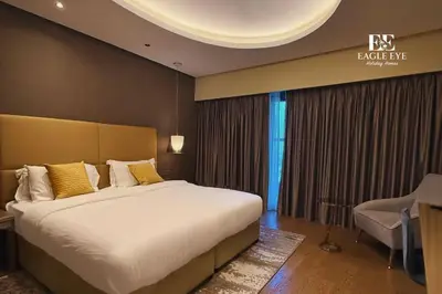 a bedroom with a bed and a desk and a chair at EEHH 1BR - 8 day NYE festival - Paramount - for 4 in Dubai