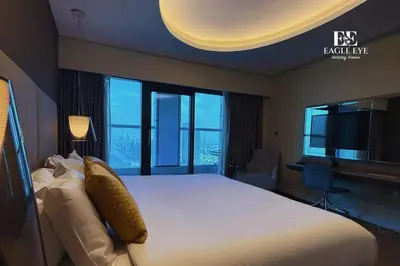 a bedroom with a large bed with a large window at EEHH 1BR - 8 day NYE festival - Paramount - for 4 in Dubai