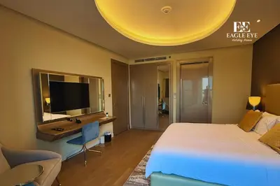 a bedroom with a bed and a desk with a television at EEHH 1BR - 8 day NYE festival - Paramount - for 4 in Dubai