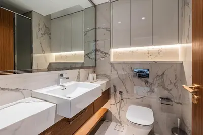 a white bathroom with a sink and a toilet at Modern Studio Apartment with Outdoor views I Azizi 67 in Dubai