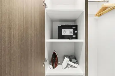 a cupboard with a microwave and a door open at Beautiful unit with canal view ! DAMAC PRIVE in Dubai