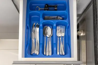 a blue tray with utensils in a drawer at Beautiful unit with canal view ! DAMAC PRIVE in Dubai