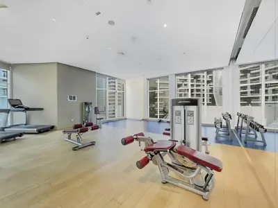 a gym with several exercise equipment in a building at Beautiful unit with canal view ! DAMAC PRIVE in Dubai