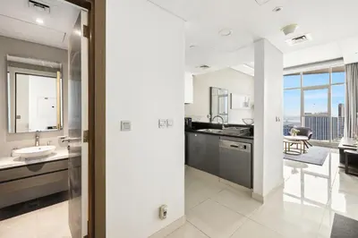 an open kitchen and dining room with a view of the city at Beautiful unit with canal view ! DAMAC PRIVE in Dubai
