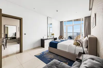 a bedroom with a large bed and a large window at Beautiful unit with canal view ! DAMAC PRIVE in Dubai