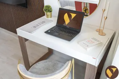 a laptop computer sitting on a white desk with a chair at Vogue JVC Luma22 near Circle Mall, Studio Apartment with Balcony and Vibrant Community View, Access to all amenities in Dubai