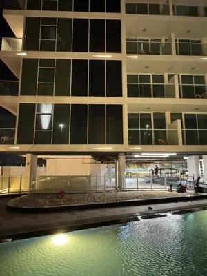 a building with a pool of water in front of it at Smart Studio in Gemz in Dubai