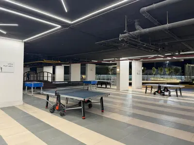 a large room with ping pong tables in it at Smart Studio in Gemz in Dubai