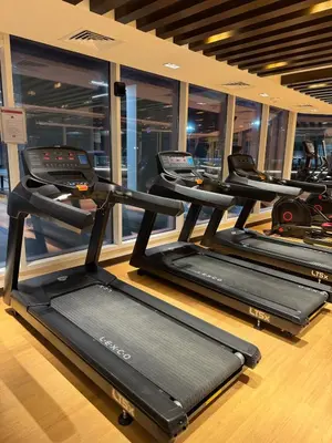 a row of treadmills in a gym at Smart Studio in Gemz in Dubai