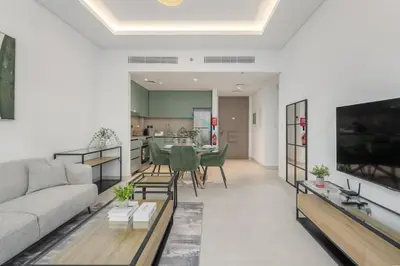 a living room with a couch and a table at Prime location near the park, just minutes from the metro, with easy access to all of Downtown Dubai attractions, Viridian, Al Wasl by Deluxe Holiday Homes in Dubai