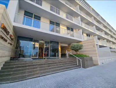 a large building with stairs in front of it at Vogue JVC Luma22 near Circle Mall, Studio Apartment with Balcony and Vibrant Community View, Access to all Amenities in Dubai