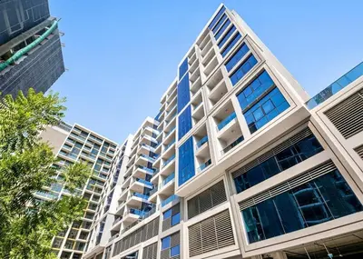 a large white building with blue windows on it at Brand New Luxury Home in a prime location in Dubai