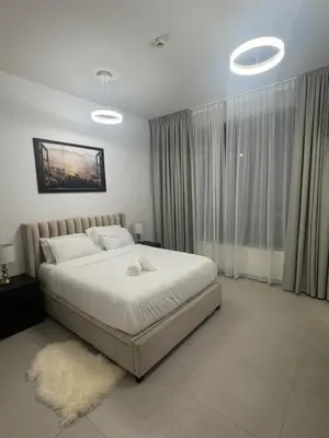 a bedroom with a large white bed with a rug at Brand New Luxury Home in a prime location in Dubai