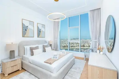 a white bedroom with a bed and a large window at PVH - Coastal 2BR with Beach Access - Atlantic Oceana in Dubai