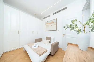 a white living room with a couch and a table at PVH - Coastal 2BR with Beach Access - Atlantic Oceana in Dubai