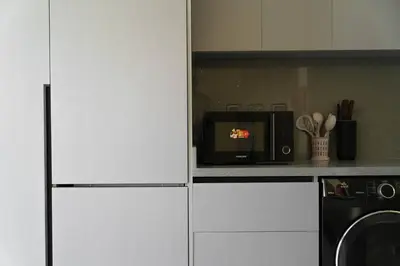 a kitchen with a microwave oven and a stove at Meydan Boutique Loft Near Downtown in Dubai