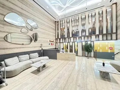 a living room with a couch and a table at Vogue JVC Luma22 near Circle Mall, Studio Apartment with Balcony and Vibrant Community View, Access to all Amenities in Dubai