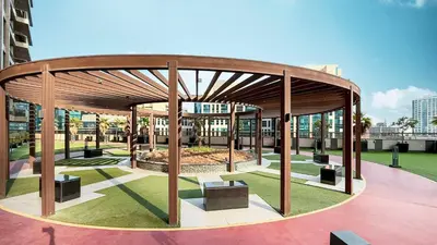 a wooden pavilion with benches in a park at Enjoy 8-Day NYE Spectacles with Burj Khalifa View in Dubai