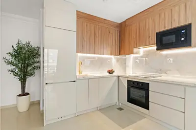 a kitchen with white cabinets and a potted plant at VayK - Vibrant and Great 1BR in the Marina in Dubai