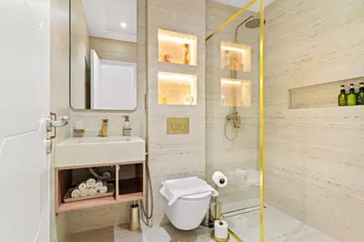 a bathroom with a sink and a toilet and a mirror at VayK - Vibrant and Great 1BR in the Marina in Dubai